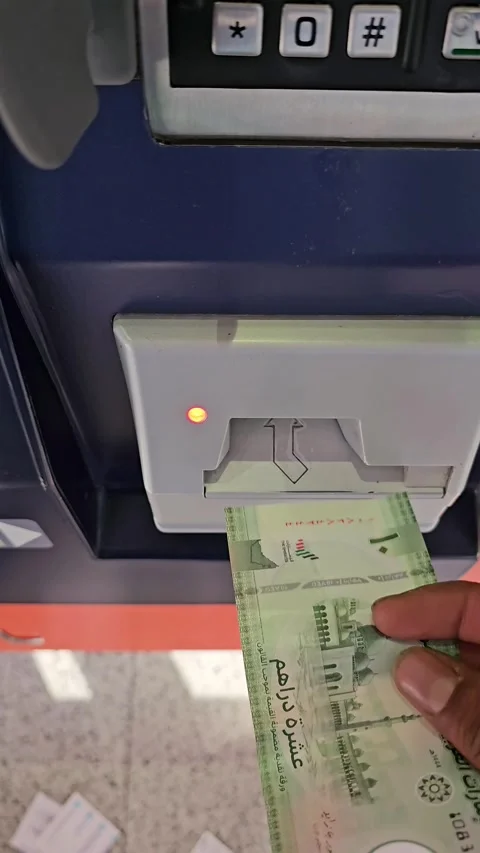 A UAE 20 dirham note is being inserted into a NOL recharge machine. Video stock 311589207