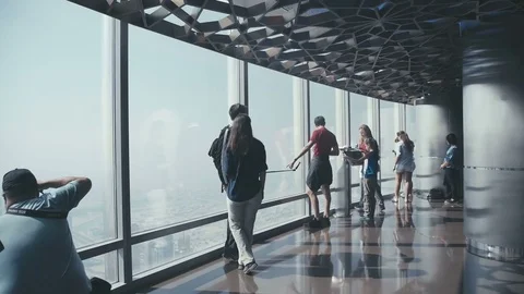 UAE, 2017: Tourists in front of the panoramic windows on skyscraper Video stock 72319276