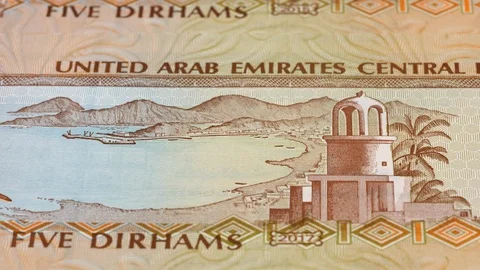 UAE 5 dirham banknotes tracking. Emirates currency. Slider shot, low angle. 4K Stock Footage 125989788