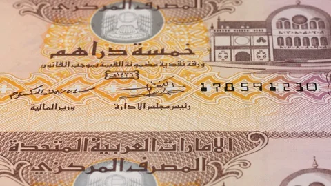 UAE 5 dirham notes tracking. Emirates currency. Slider shot, low angle. 4K Stock Footage 125988909