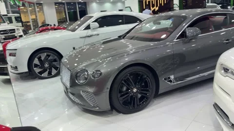 UAE - August 18, 2026 - Luxury supercars inside a showroom Stock Footage 342619409