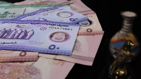 UAE Dirham bank notes rotating on an automatic table Stock Footage 271687060
