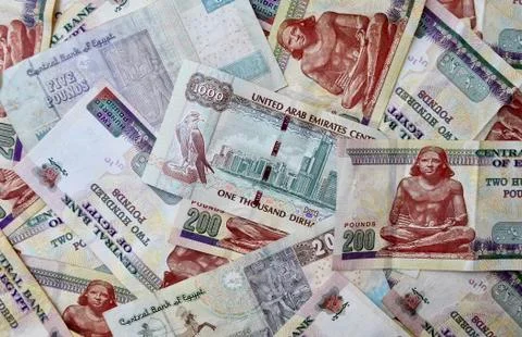 UAE dirham banknote on the top of Egypt national currency backdrop. Stock Photos