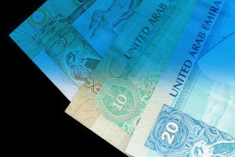 UAE dirham currency notes close up. Money background blue color toned Foto stock