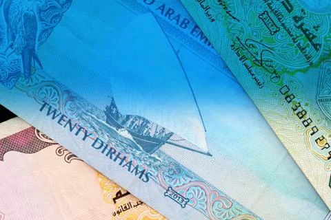 UAE dirham currency notes close up. Money background blue color toned Foto stock