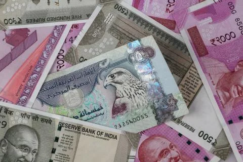 UAE Dirhams between Indian New Currency Bank Notes Stock Photos