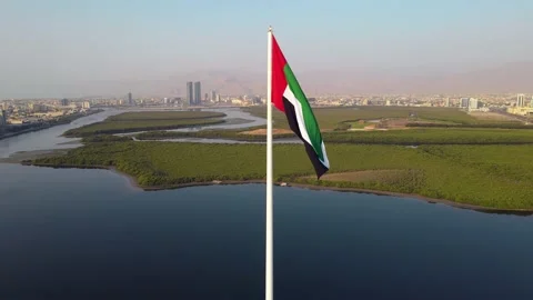 UAE flag and Ras al Khaimah emirate in the north United Arab Emirates aerial  Stock Footage 154534223