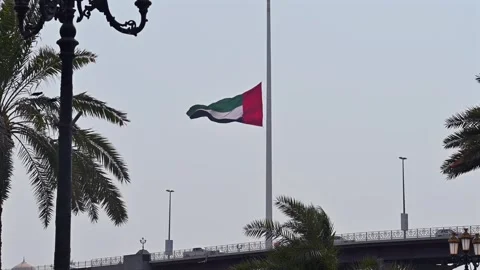 The UAE flag flying at half-mast during a period of national mourning. Stock Footage 341615638