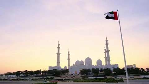 UAE flag gracefully waving against vibrant sunset sky, Stock Footage 337713573