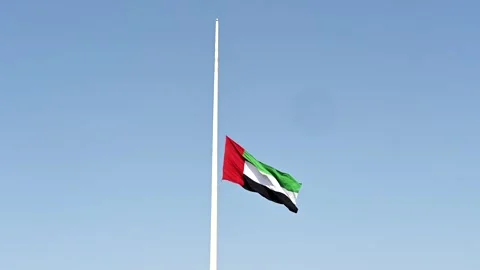 The UAE flag lowered as a symbol of mourning and unity. Stock Footage 341615551