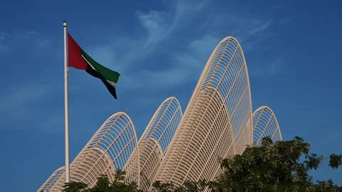 The UAE flag waves proudly in front of the Zayed National Museum, the national 動画素材 322782715