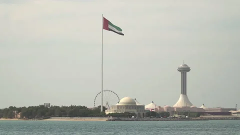 UAE flag waves in the wind at the waterfront of Al Marina district in Abu Dhabi Stock Footage 172555410