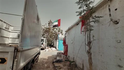A UAE flag waving in the air in an old town in Sharjah, UAE. Stock Footage 335962725