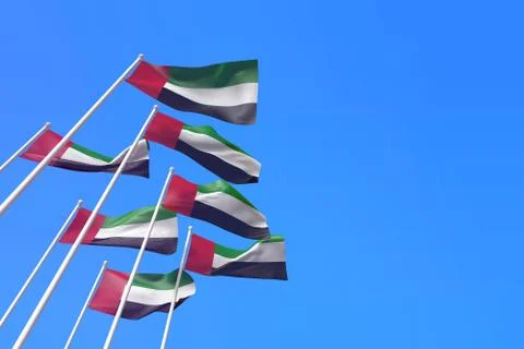 UAE flags waving in the wind against a blue sky. 3D Rendering Stock Illustration