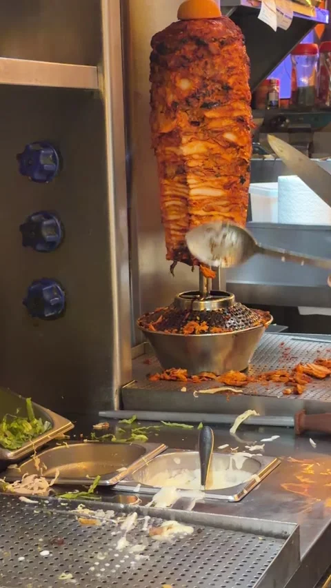 UAE - September 18, 2026 - Shawarma meat rotating on vertical spit inside a.. Stock Footage 345773585