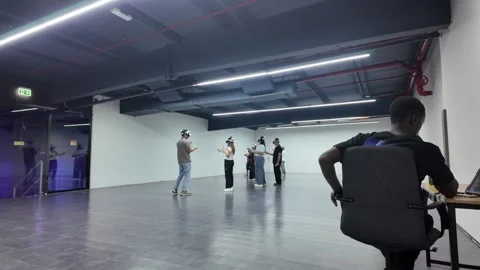 UAE - September 25, 2026 - Visitors experiencing immersive VR gaming and in.. Stock Footage 346458858