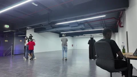 UAE - September 25, 2026 - Visitors experiencing immersive VR gaming and in.. Stock Footage 346460017