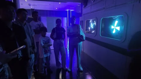 UAE - September 25, 2026 - Visitors experiencing immersive VR gaming and in.. Stock Footage 346469416