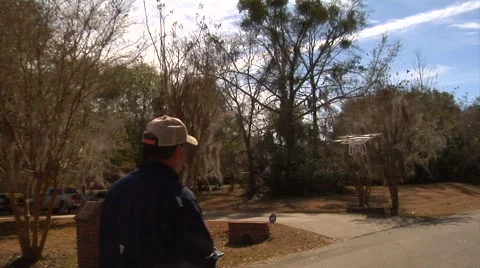UAV-7, drone helicopter, licensed pilot walk behind UAV while in operation Stock Footage 47253292