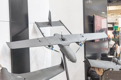 UAV drone at tech exhibition, showcasing sleek design, modern booth setting.. Stock Photos
