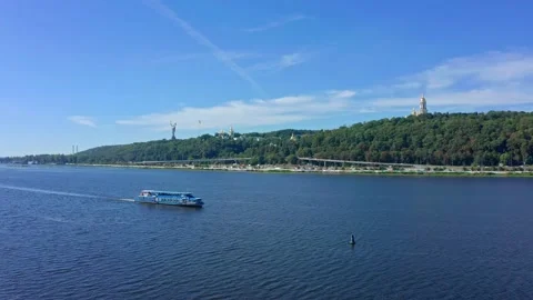 UAV flight over the Dnieper river with a passing tourist boat in the directio Stock Footage 139747199