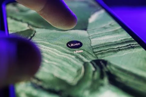 Uber app on smartphone screen. Close up shot of Uber app Stock Photos