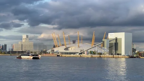 Uber boat clipper service close up passing whilst O2 behind Stock Footage 218968564