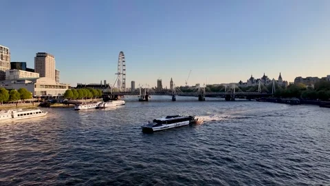 Uber Boat by Thames Clippers ferry cruising River Thames with London Eye and 動画素材 334294287