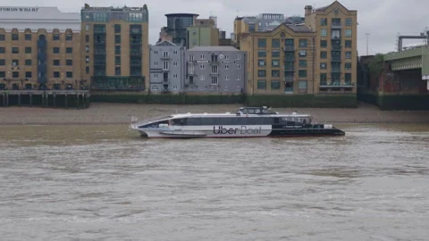 Uber Boat by Thames Clippers going down the River Thames through London Stock Footage 345536058