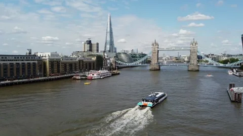 Uber boat by Thames clippers heading for Tower bridge London UK drone aerial Stock Footage 345887034