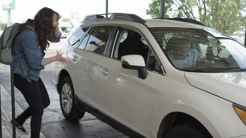 Uber driver pulls up to pick up young woman Stock Footage 92830681