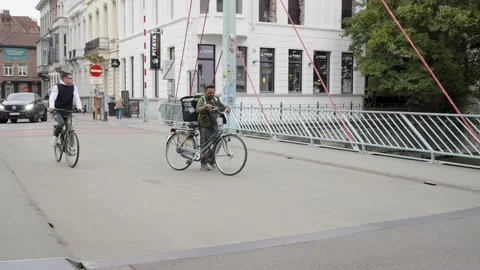 Uber Eats courier with bike problem walking next to bicycle during Stock Footage 196849252