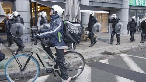 Uber eats delivery bike driver can't deliver at client due to barricade of Stock Footage 166661195