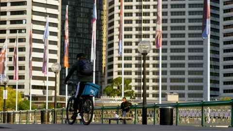 Uber Eats delivery cyclist through Sydney slow motion 4K Stock Footage 149150398