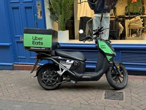 Uber Eats delivery scooter Stock Photos