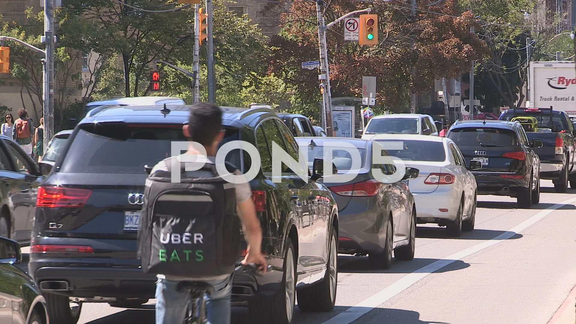 Uber eats driver on bike delivers food in traffic jam