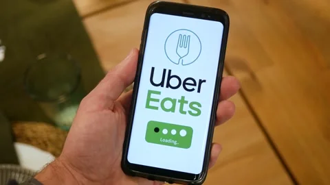 Uber Eats Food Delivery app Loading on a Smartphone Screen Stock Footage 144035414