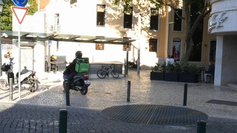 Uber Eats food delivery driver on a vespa picking up food from a McDonald's fast Stock Footage 110879405
