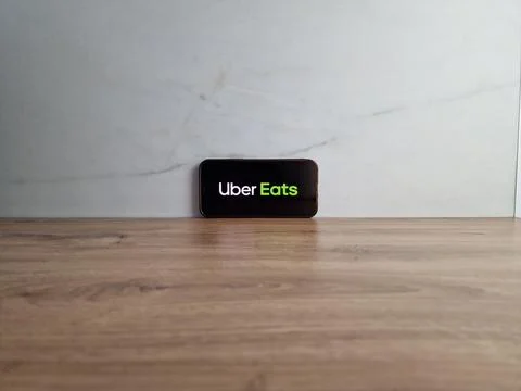 Uber Eats logo displayed on mobile phone Stock Photos
