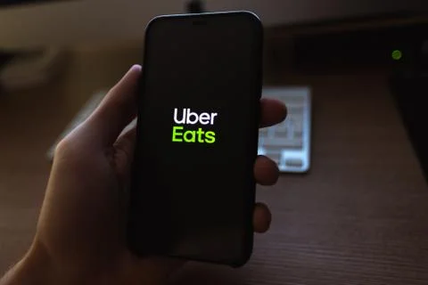 Uber Eats logo on the smartphone screen Stock Photos