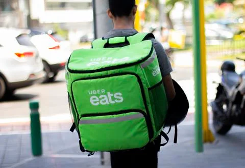 Uber eats man working at food delivery service Stock Photos