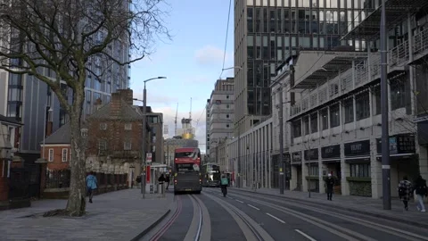 An Uber Eats or Deliveroo cyclist on the Birmingham city centre streets 動画素材 258337475