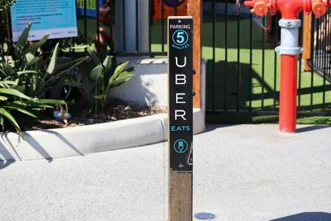 Uber eats parking sign on a post in a carpark Foto stock