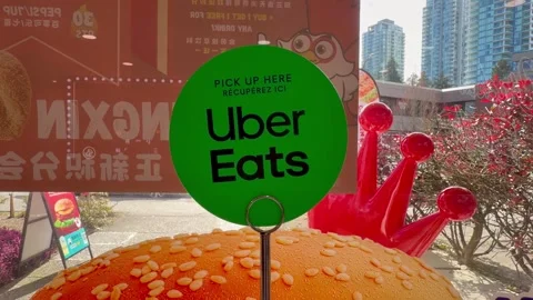 Uber Eats Signage and Food Pickup Point in Urban City Setting Stock Footage 332925382
