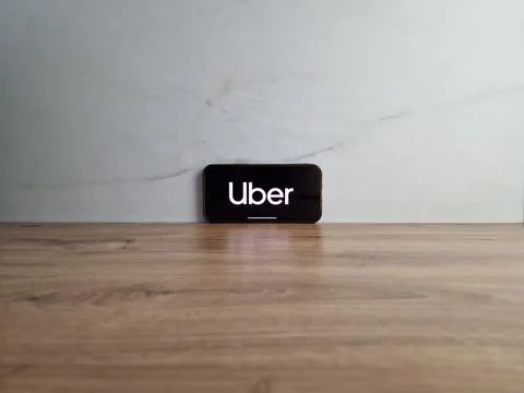 Uber logo displayed on mobile phone Stock Photos