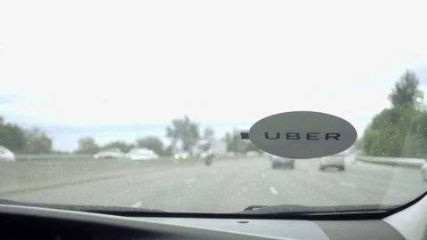 Uber sticker on windshield from passenger view seat pov on freeway in LA CA Stock Footage 70611100