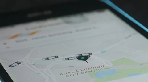  UBER user looking at the available UBER Cars around Kuala Lumpur City Centre. Stock Footage