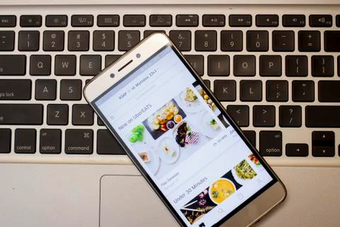 Uber User Opening Uber App On His Smartphone To get the food delivery Stock Photos