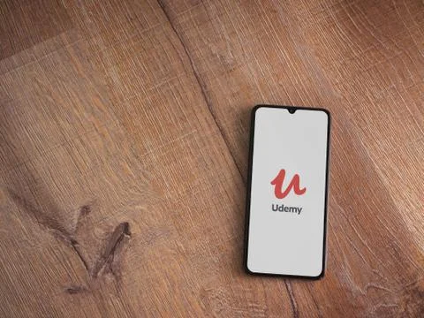 Udemy app launch screen with logo on the display of a black mobile smartphone Stock Photos