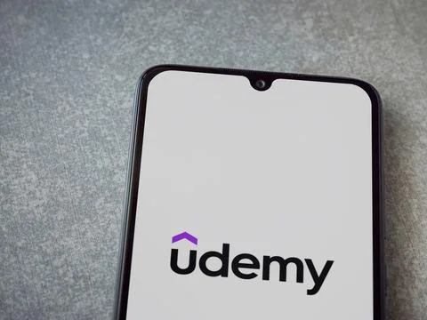 Udemy app launch screen on smartphone on ceramic stone background Stock Photos